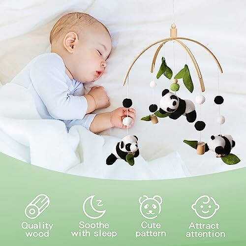 Sleeping baby with panda-themed mobile overhead.