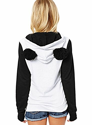 Rear view of person wearing a white and black hoodie with pom-poms.