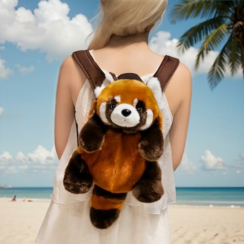 Person with red panda backpack on a beach