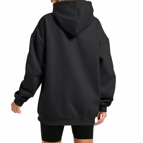 Back view of person wearing a black hoodie.