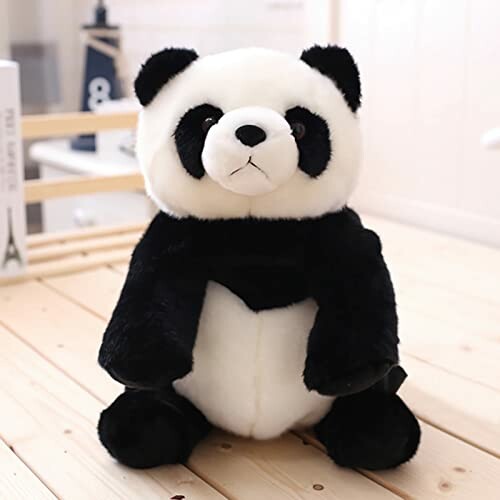 Cute panda plush toy on a wooden surface