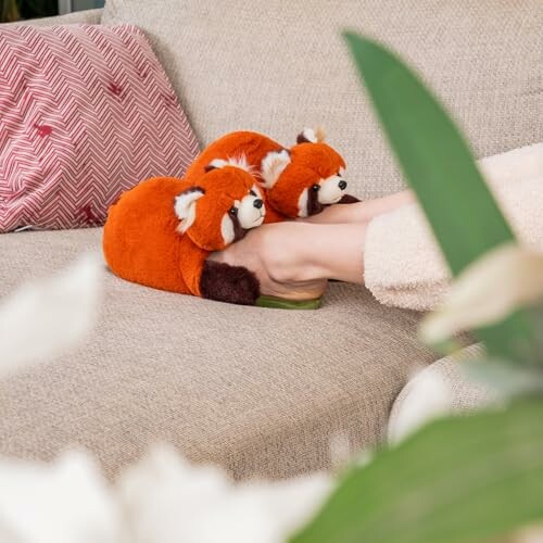 Person wearing fox slippers on a sofa