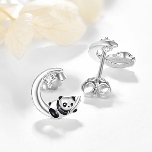 Panda-themed earrings with a small gemstone