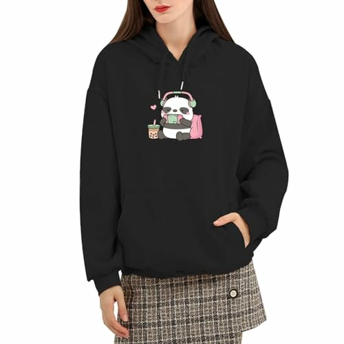 Woman wearing a black hoodie with a cute panda design.