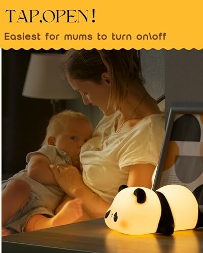 Mother holding baby with a panda night light on table.