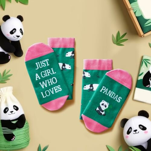 Green and pink socks with panda designs and text.