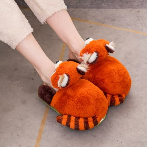 Feet wearing red panda plush slippers