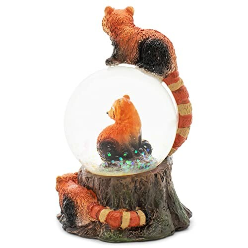 Red panda snow globe with figurines on top and base.