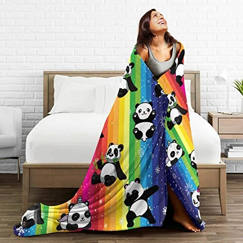 Woman wrapped in a rainbow panda blanket in bedroom.