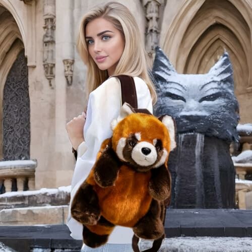 Woman with red panda backpack in front of cat statue