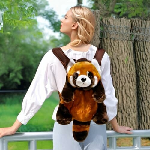 Woman wearing red panda plush backpack outdoors